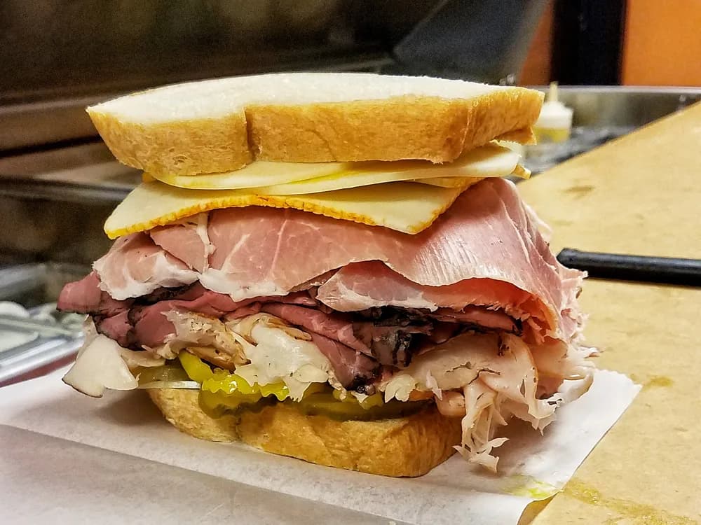 A stacked deli sandwich on the counter